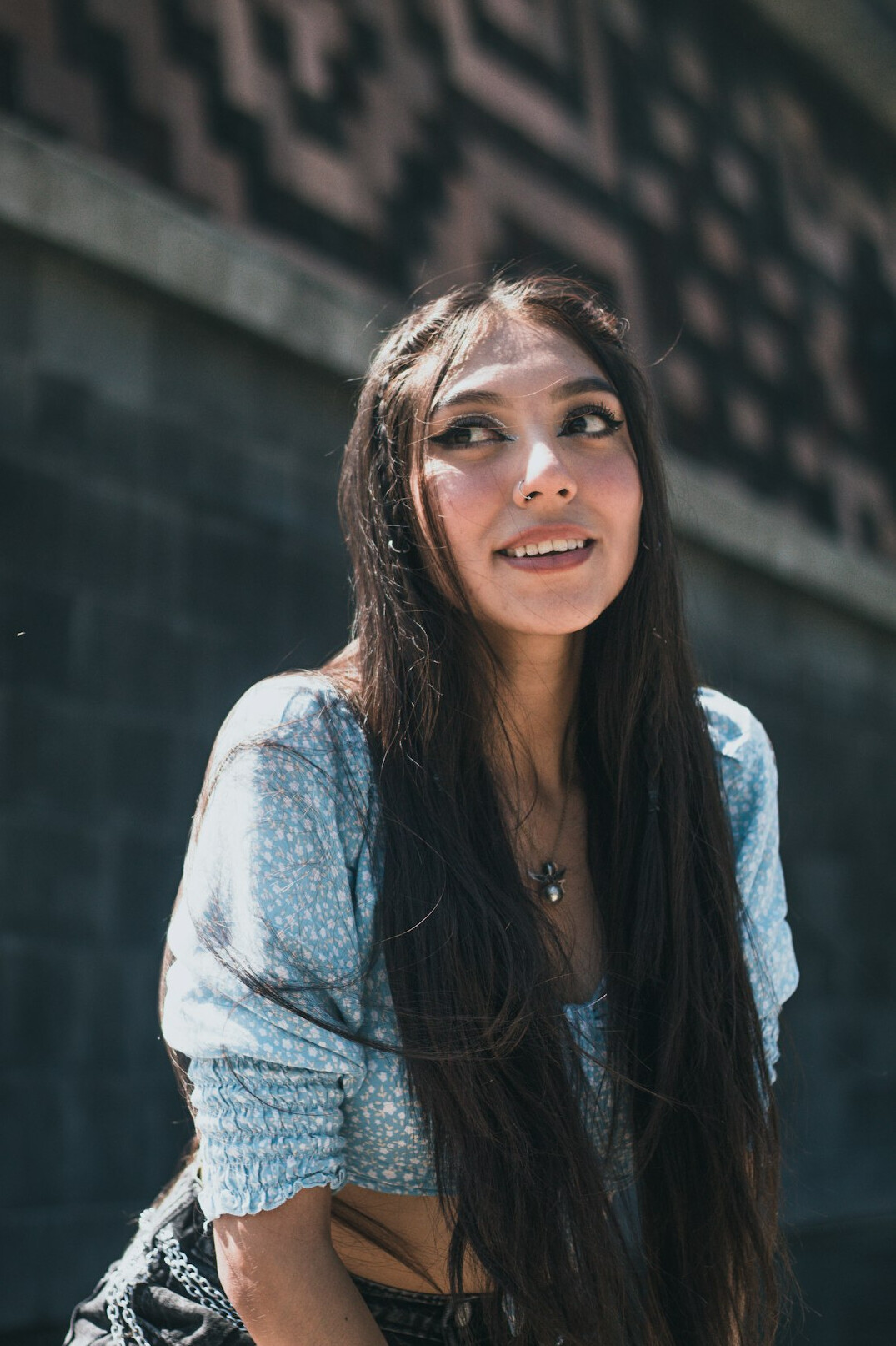 Portrait of a woman with long dark hair smiling
