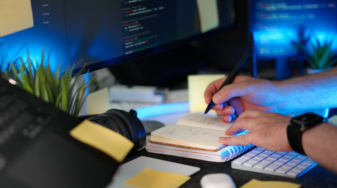 person coding at desk