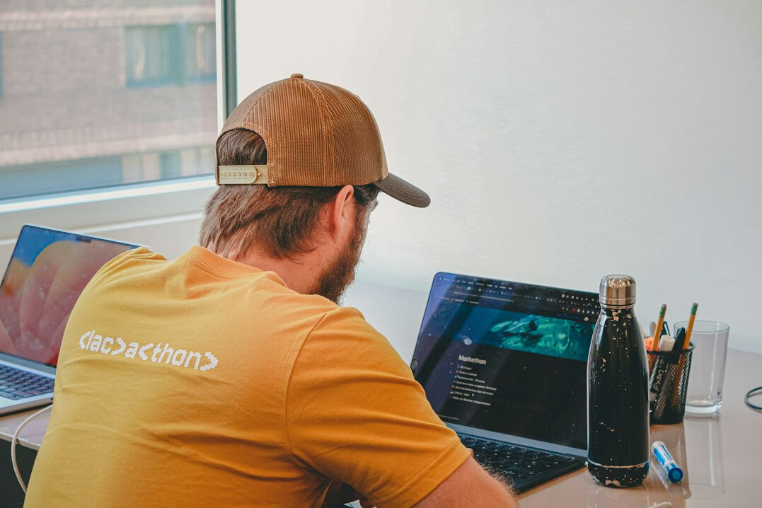 person writing code at desk